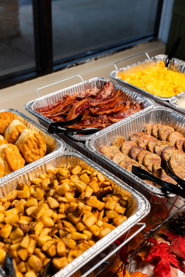 Buffet of biscuits, bacon, eggs, sausage and moon dusted potatoes